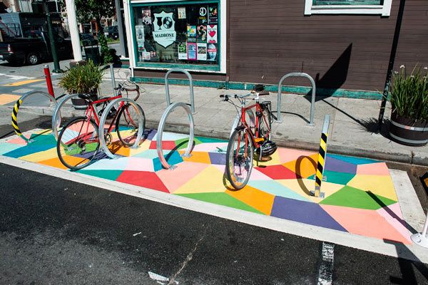 a bike rack that has vibrant mural-like paintings